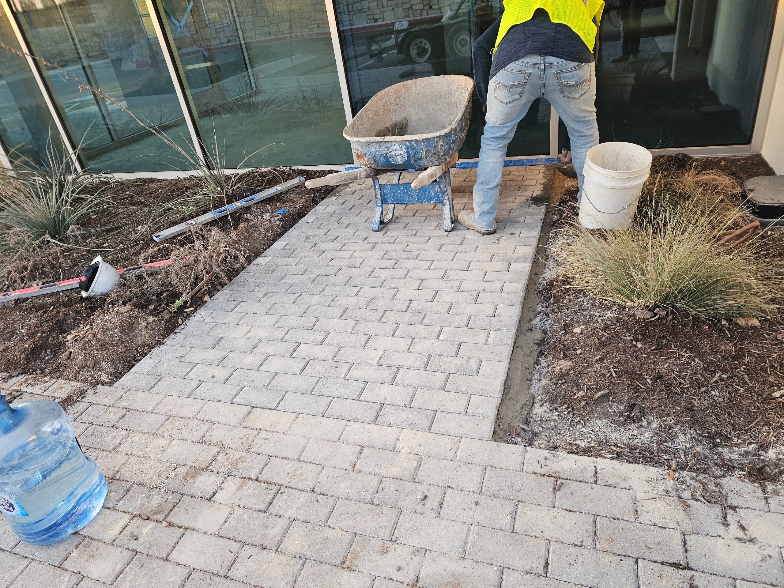 Dark cobblestone paver installation in progress — Ancfence LLC