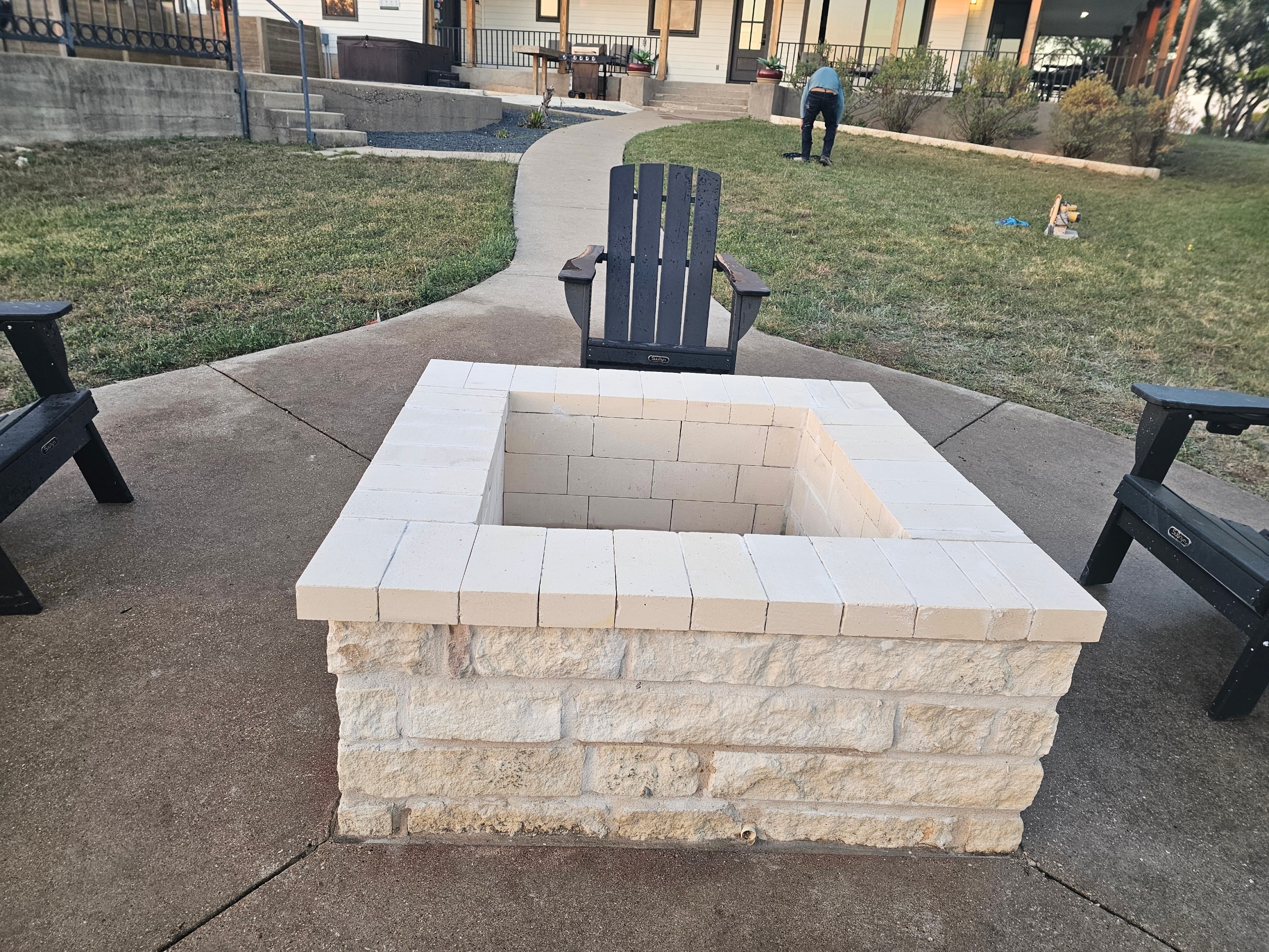 Custom limestone fire pit with Adirondack chairs — Ancfence LLC masonry