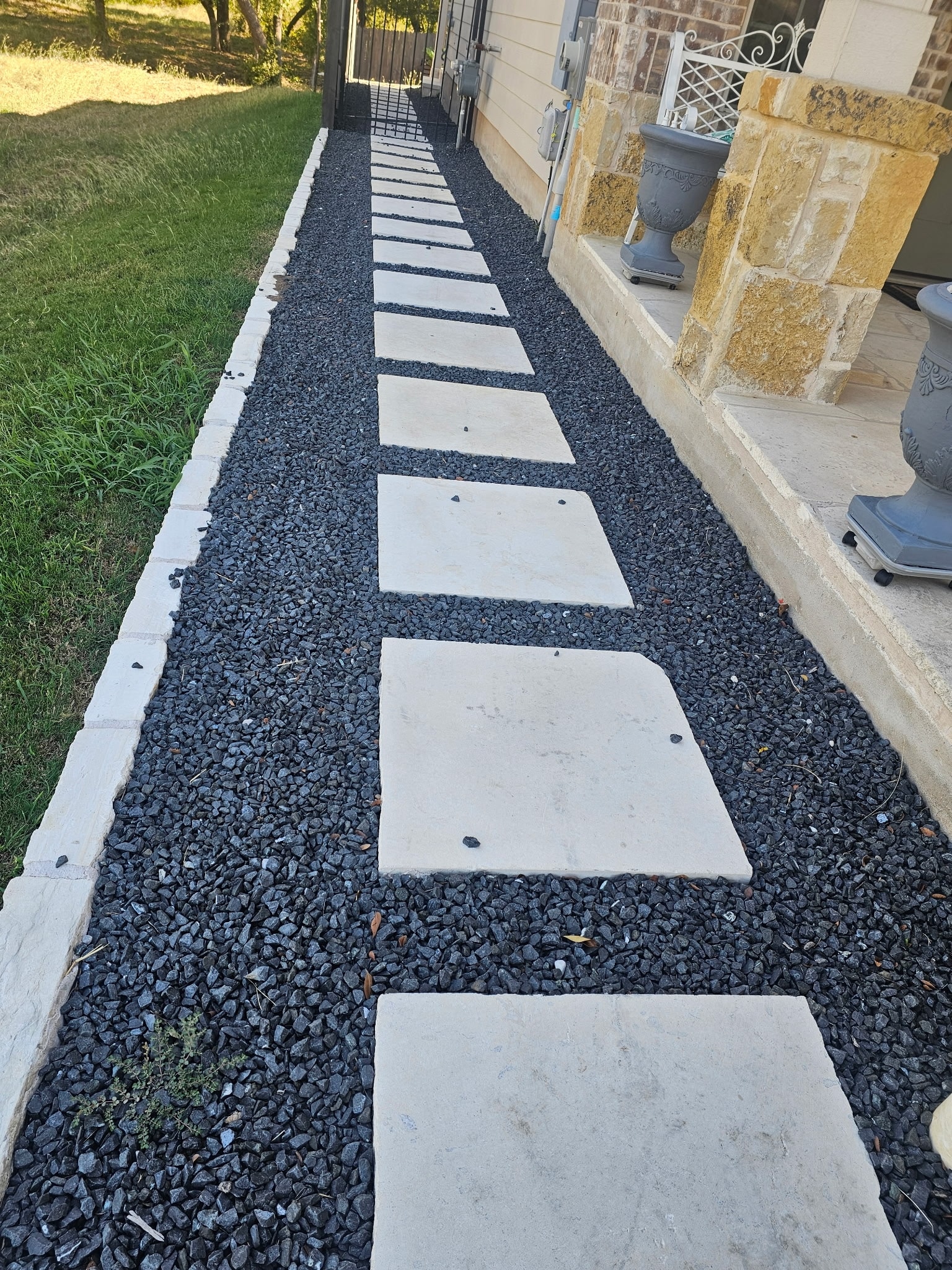 Large concrete slab stepping stones with black gravel — Ancfence LLC