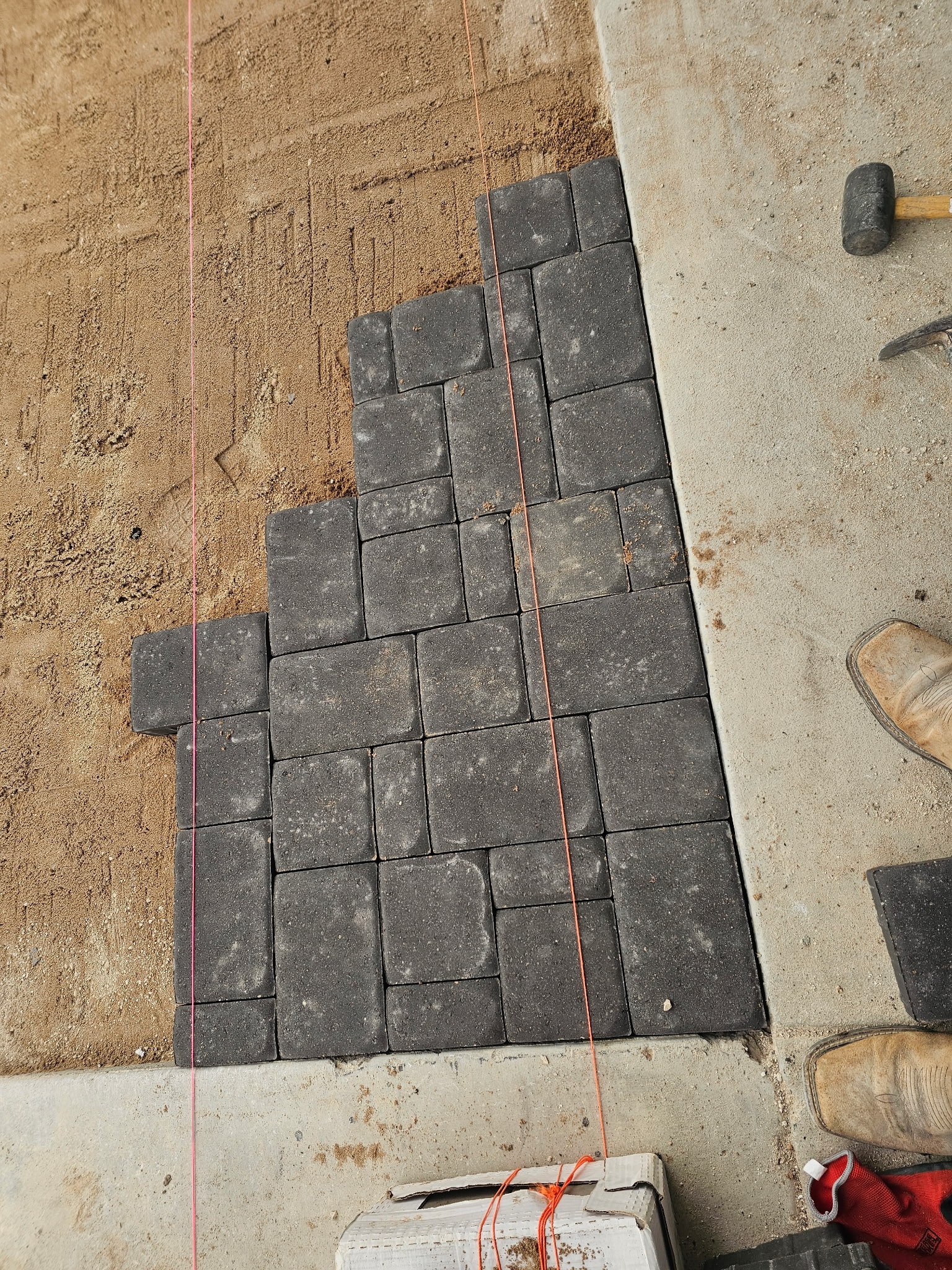 Concrete stepping stone pathway with black gravel — Ancfence LLC masonry Round Rock TX